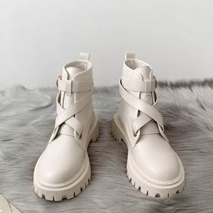 Chunky beige combat boots with cross front strap detail